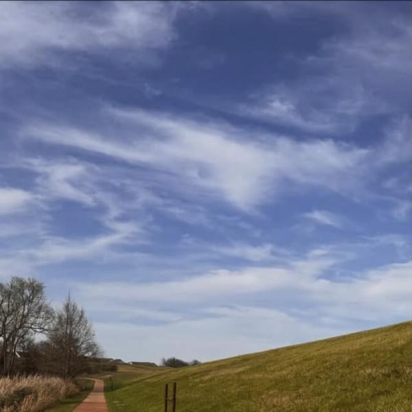 Trail under a wide blue sky with streaky clouds in Kyle, Texas